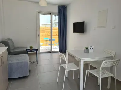 a living room with a white table and chairs at Tefkrou Anthia 9 apts in Ayia Napa