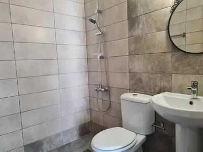 a bathroom with a toilet and a sink at Tefkrou Anthia 9 apts in Ayia Napa