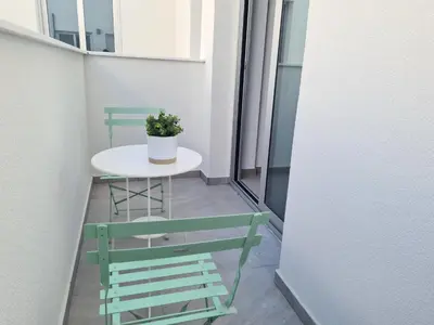 a small table and chairs on a balcony at Tefkrou Anthia 9 apts in Ayia Napa