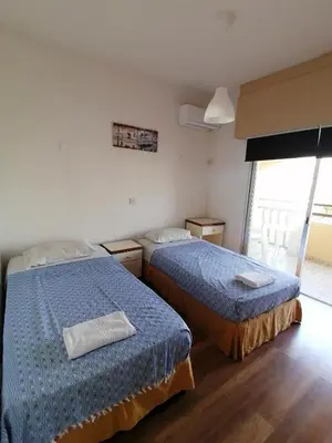 a room with two beds in a room at TERPSICHORE Holiday Apts in Limassol