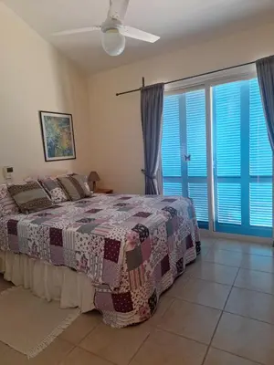 a bedroom with a bed and a large window at Melanta Villa in Pissouri