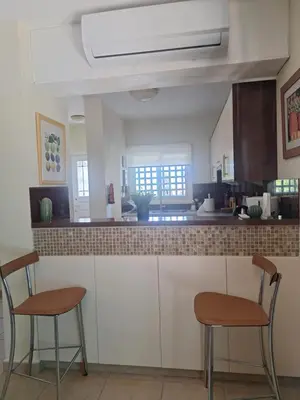 a kitchen with two chairs and a counter at Melanta Villa in Pissouri