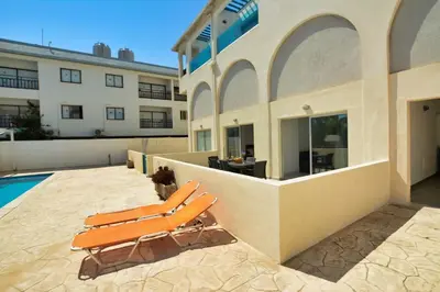 a couple of lounge chairs sitting on the side of a building at MyHome DeLux, Ayia Napa 3 Bedroom with Pool in Ayia Napa