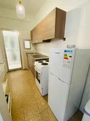 a kitchen with a white refrigerator and a stove at Simple One bedroom flat in Engomi in Engomi