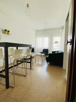 a living room with a couch and a table and chairs at Simple One bedroom flat in Engomi in Engomi