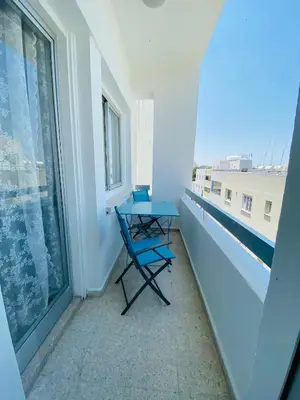 a balcony with a blue table and a window at Simple One bedroom flat in Engomi in Engomi