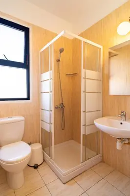 a bathroom with a shower and a toilet and a sink at Mirabella Mackenzie 1 Bedroom Flat Near the Sea in Larnaka