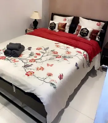 a bedroom with a bed with a red and white blanket at Larnaca Room, 50m to the Finikoudes beach in Larnaka