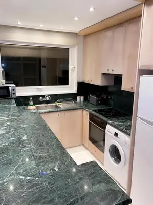 a kitchen with a green marble counter top at Larnaca Room, 50m to the Finikoudes beach in Larnaka