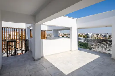 a white balcony with a view of a city at Solaar Apartments st Lazarous in Larnaka