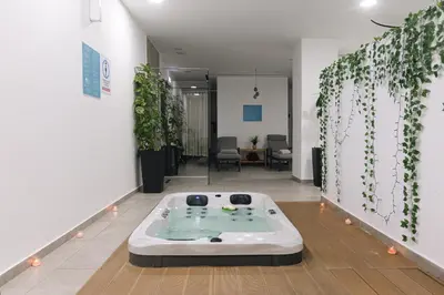 a room with a bath tub in the middle of a room at Caramela Luxury Apts in Ayia Napa