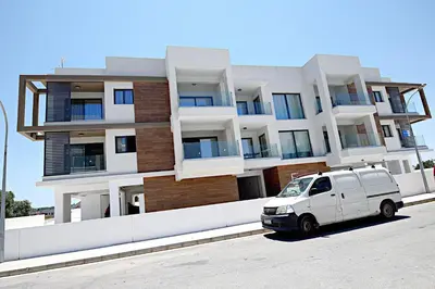 a white van parked in front of a building at Golden Tree Apartment in Paralimni
