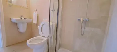 a bathroom with a shower and a toilet and a sink at STAY Trinity Beach Apts in Paralimni