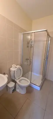 a bathroom with a shower and a toilet and a sink at STAY Trinity Beach Apts in Paralimni