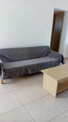 a bed with a blanket on the floor in a room at Napa Charles Apts in Ayia Napa