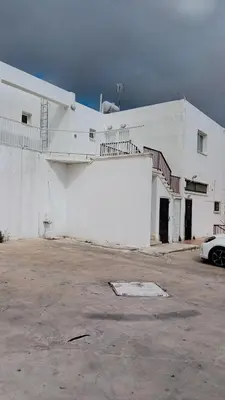 a white building with stairs on the side of it at Napa Charles Apts in Ayia Napa
