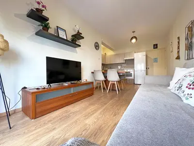 a living room with a large flat screen tv at Albert's Apartment Mackenzie 001 in Larnaka