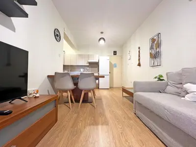 a living room with a couch and a table at Albert's Apartment Mackenzie 001 in Larnaka