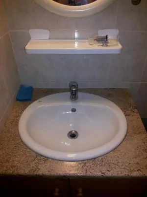 a white sink sitting on a counter in a bathroom at Apartments Mackenzie 1+1 in Larnaka