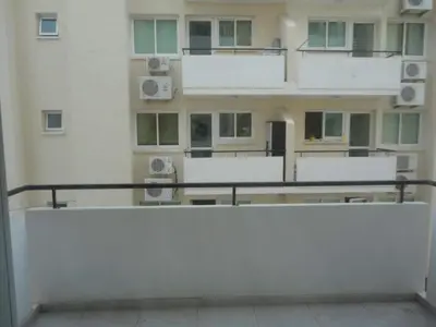 a view of a large building with windows at Apartments Mackenzie 1+1 in Larnaka