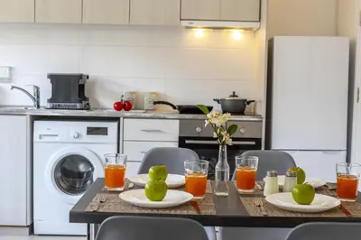 a kitchen with a table with fruit on it at C-Premium Apts 100m from beach and city centre in Larnaka