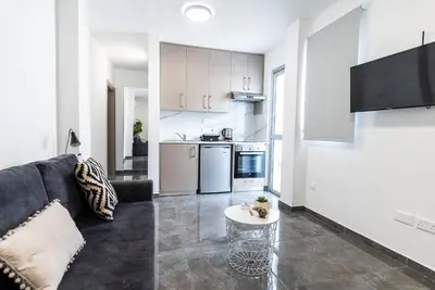 a living room with a couch and a table at Spiros Luxury Apartments in Ayia Napa