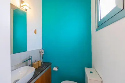 a bathroom with a white toilet and a blue wall at Protaras Villa Elena 3 in Protaras