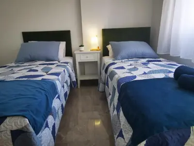 two beds sitting next to each other in a room at Hawaii Holiday Apartment 41 in Limassol