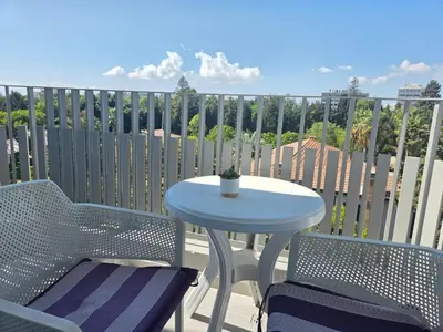 a table and two chairs on a balcony with a table at Hawaii Holiday Apartment 41 in Limassol