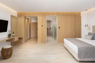 a hotel room with a bed and a bathroom at Atlantica Bay - Adults Only in Limassol