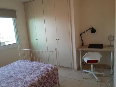 a bedroom with a bed and a desk and a chair at Larnaca Xylophagou 2-bedroom apartment with a shaded terrace in Xylophaghou