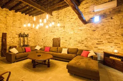 a living room with a couch and a table at Whitestone Mill in Pano Lefkara