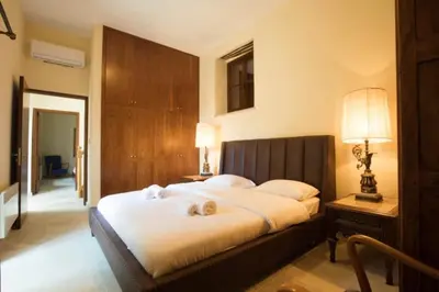 a bedroom with a bed with two dogs laying on it at Whitestone Mill in Pano Lefkara