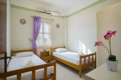 a bedroom with two beds and a window at Vitamin Sea Protaras in Protaras