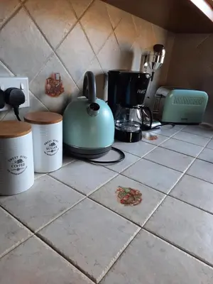 a kitchen counter with a tea kettle and other appliances at House de Fountas in Khandria