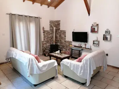 a living room with two chairs and a tv at House de Fountas in Khandria