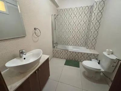 a bathroom with a sink and a toilet and a shower at Central Large 2BD APT near the Beach in Larnaka