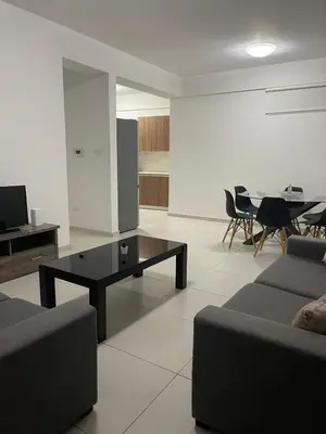 a living room with a couch and a coffee table at Central Large 2BD APT near the Beach in Larnaka
