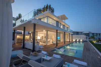 a home with a swimming pool and a house at Villa Olivine Pearl 3 in Protaras