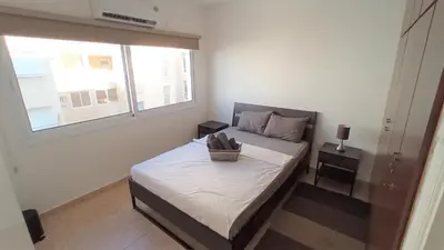 a small bedroom with a bed with a basket on it at 5 min to the Beach Holiday Shared Apartment - private ROOM in 3 bdr Apt in Larnaka