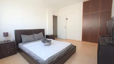 a bedroom with a bed with a basket on it at 5 min to the Beach Holiday Shared Apartment - private ROOM in 3 bdr Apt in Larnaka