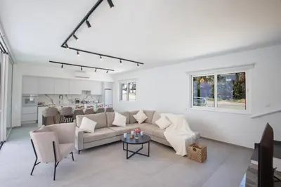 a living room with a couch and a table at Kube Luxury Villas in Ayia Napa