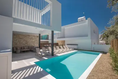 a swimming pool in the backyard of a house at Kube Luxury Villas in Ayia Napa