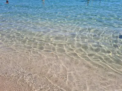 a group of people swimming in the water at Walk to Protaras Center & Beach- Your Dream Escape, Blue Island Villa in Protaras