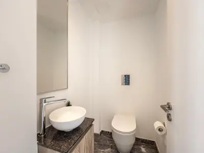 a bathroom with a white sink and a toilet at Almaria Residences in Paralimni