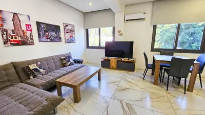 a living room with a couch and a table at Mimi's Sunny Beach Apartment in Larnaka