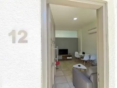 a living room with a couch and a table at FlipFlop City Center Apartment in Larnaka