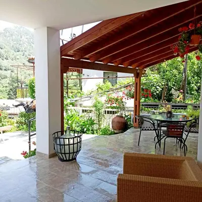 a patio with a table and chairs on a patio at BELLE VUE Mountain Home in Kalopanayiotis