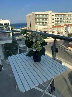 a potted plant sitting on a bench on a balcony at One-bedroom beach apartment, 30m from an amazing beach, Coralli in Protaras