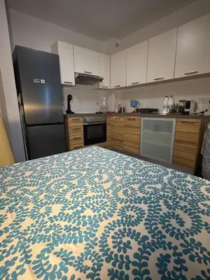 a kitchen with a blue and white pattern on a bed at One-bedroom beach apartment, 30m from an amazing beach, Coralli in Protaras